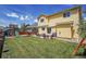 Spacious backyard features a well-manicured lawn, patio area and a play structure at 5338 Potentilla St, Brighton, CO 80601