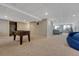 Carpeted basement featuring game area, seating, and storage at 5338 Potentilla St, Brighton, CO 80601