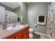 Cozy bathroom with wood vanity, shower and tub combination and neutral wall color at 5338 Potentilla St, Brighton, CO 80601