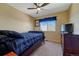 Bedroom with carpet, ceiling fan, window and dark wood trim at 5338 Potentilla St, Brighton, CO 80601