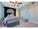 Stylish bedroom with a queen bed, decorative tapestry, and soft blue walls at 5338 Potentilla St, Brighton, CO 80601