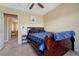 Bedroom features a wooden sleigh bed and plush blue blankets at 5338 Potentilla St, Brighton, CO 80601