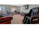 Cozy bonus room featuring a large seating arrangement and a mounted television at 5338 Potentilla St, Brighton, CO 80601