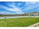 Beautiful community pool and playground surrounded by lush green grass and neighborhood homes at 5338 Potentilla St, Brighton, CO 80601