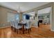 Elegant dining room with a chandelier, hardwood floors, and seating for six at 5338 Potentilla St, Brighton, CO 80601