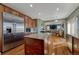 Modern kitchen featuring a granite island, stainless steel appliances, and hardwood floors at 5338 Potentilla St, Brighton, CO 80601