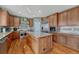 Spacious kitchen featuring wood cabinets, stainless steel appliances, and granite countertops at 5338 Potentilla St, Brighton, CO 80601