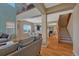 Bright and airy living room with high ceilings, hardwood floors, and an open floor plan to the dining area at 5338 Potentilla St, Brighton, CO 80601