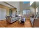 Inviting living room featuring hardwood floors, neutral decor, and plenty of natural light at 5338 Potentilla St, Brighton, CO 80601