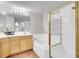 Well-lit bathroom featuring a vanity, soaking tub, and separate shower with glass doors at 12483 E Wesley Ave, Aurora, CO 80014