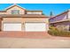 Attached two car garage with white doors and stamped concrete driveway at 12483 E Wesley Ave, Aurora, CO 80014