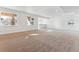 Finished basement with neutral carpeting and wet bar at 8773 Yellowcress St, Littleton, CO 80125