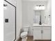 Bathroom with white vanity, toilet and a shower at 8773 Yellowcress St, Littleton, CO 80125