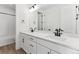 Double vanity bathroom with modern fixtures and white cabinets at 8773 Yellowcress St, Littleton, CO 80125