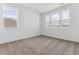 Bright bedroom featuring neutral carpeting and multiple windows at 8773 Yellowcress St, Littleton, CO 80125