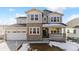 Two-story house with stone facade and attached garage at 8773 Yellowcress St, Littleton, CO 80125