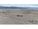 Expansive aerial view of a home in a field surrounded by mountains in the distance at 5540 Horseshoe Trl, Sedalia, CO 80135