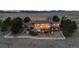 Wide aerial view of the back of the home showing mountain views and white fence line at 5540 Horseshoe Trl, Sedalia, CO 80135