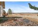 Picturesque backyard with a rock garden, pond, and views of the surrounding landscape with fencing at 5540 Horseshoe Trl, Sedalia, CO 80135