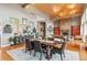 Dining area featuring a wood table, vaulted ceiling, and an open-concept layout at 5540 Horseshoe Trl, Sedalia, CO 80135