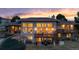 Back exterior of home showcasing large windows, deck and patio at twilight at 5540 Horseshoe Trl, Sedalia, CO 80135