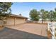 Spacious three car garage, driveway, and a well manicured yard and adjacent white fence at 5540 Horseshoe Trl, Sedalia, CO 80135
