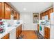 Charming kitchen with wood cabinets, white appliances, and an inviting atmosphere for cooking and dining at 5540 Horseshoe Trl, Sedalia, CO 80135