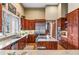 Open-concept kitchen with stainless appliances, granite countertops, and an island with a gas cooktop at 5540 Horseshoe Trl, Sedalia, CO 80135