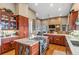 Spacious kitchen with custom cabinets, granite countertops, and stainless steel appliances at 5540 Horseshoe Trl, Sedalia, CO 80135