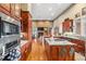 Open kitchen with a center island, custom cabinetry, and modern stainless steel appliances at 5540 Horseshoe Trl, Sedalia, CO 80135