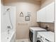 Laundry room featuring a tub shower combination and modern washer and dryer at 5540 Horseshoe Trl, Sedalia, CO 80135