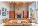 Spacious living room with a stone fireplace, custom built-ins, a vaulted ceiling, and comfortable seating at 5540 Horseshoe Trl, Sedalia, CO 80135