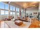 Open-concept living room with a vaulted ceiling, large windows, wood floors, and comfortable seating at 5540 Horseshoe Trl, Sedalia, CO 80135