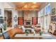Expansive living room featuring vaulted ceilings, a stone fireplace, and large windows for ample natural light at 5540 Horseshoe Trl, Sedalia, CO 80135