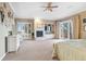 Bright main bedroom features a fireplace, large windows, built-in shelving, and access to a balcony at 5540 Horseshoe Trl, Sedalia, CO 80135