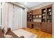 This room has built-in bookshelves, a wood floor, curtains, and a couch at 5540 Horseshoe Trl, Sedalia, CO 80135