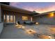 Outdoor patio space with stone pavers, modern outdoor lighting, and comfortable seating at 5540 Horseshoe Trl, Sedalia, CO 80135