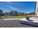 Backyard with fire pit, wood deck and green grass at 42396 Glen Abbey Dr, Elizabeth, CO 80107