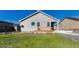 House exterior and grassy backyard with deck at 42396 Glen Abbey Dr, Elizabeth, CO 80107