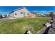 Backyard features lawn, rock ground cover and a wood deck at 42396 Glen Abbey Dr, Elizabeth, CO 80107