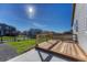 Wood deck with metal railing overlooking the backyard and surrounding neighborhood at 42396 Glen Abbey Dr, Elizabeth, CO 80107