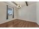 Bright dining room with hardwood floors, a beam ceiling, and a modern chandelier at 42396 Glen Abbey Dr, Elizabeth, CO 80107