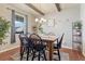 Charming dining room with a wooden table, four chairs, and hardwood floors at 42396 Glen Abbey Dr, Elizabeth, CO 80107