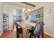 Bright dining room with a wooden table, four chairs, and hardwood floors at 42396 Glen Abbey Dr, Elizabeth, CO 80107