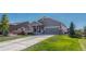 Gray exterior ranch home with stone accents, two-car garage, and landscaped lawn at 42396 Glen Abbey Dr, Elizabeth, CO 80107