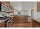 Modern kitchen with stainless steel appliances, wood floors, and granite countertops at 42396 Glen Abbey Dr, Elizabeth, CO 80107