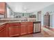 Well-equipped kitchen featuring granite countertops, stainless steel dishwasher, and wood cabinets at 42396 Glen Abbey Dr, Elizabeth, CO 80107