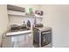 A laundry room with modern front load washer and dryer and shelving at 42396 Glen Abbey Dr, Elizabeth, CO 80107