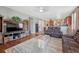 Spacious living room featuring hardwood floors, a large TV, and comfortable seating at 42396 Glen Abbey Dr, Elizabeth, CO 80107