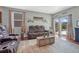 Spacious living room with brown leather reclining sofas and a view of the backyard at 42396 Glen Abbey Dr, Elizabeth, CO 80107